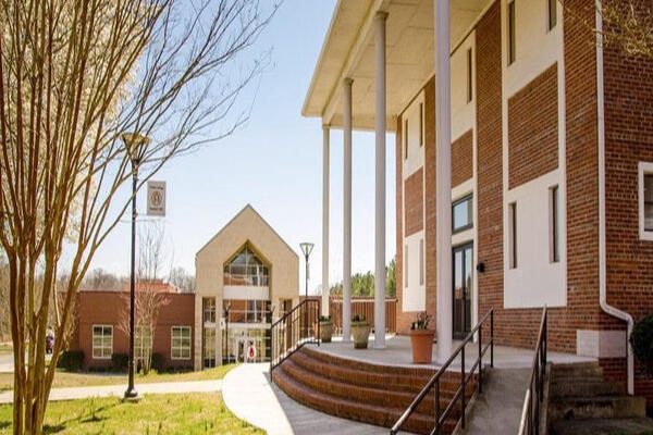 University campus buildings with columns and clear skies.